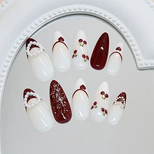 cherry press on nails, burgundy fake nails, dark red french tip nails, 3d pearl heart pressons, almond shaped glue ons, vintage aesthetic nails, handmade luxury pressons, cute winter false nails, coquette nails pack, red glitter fake nails